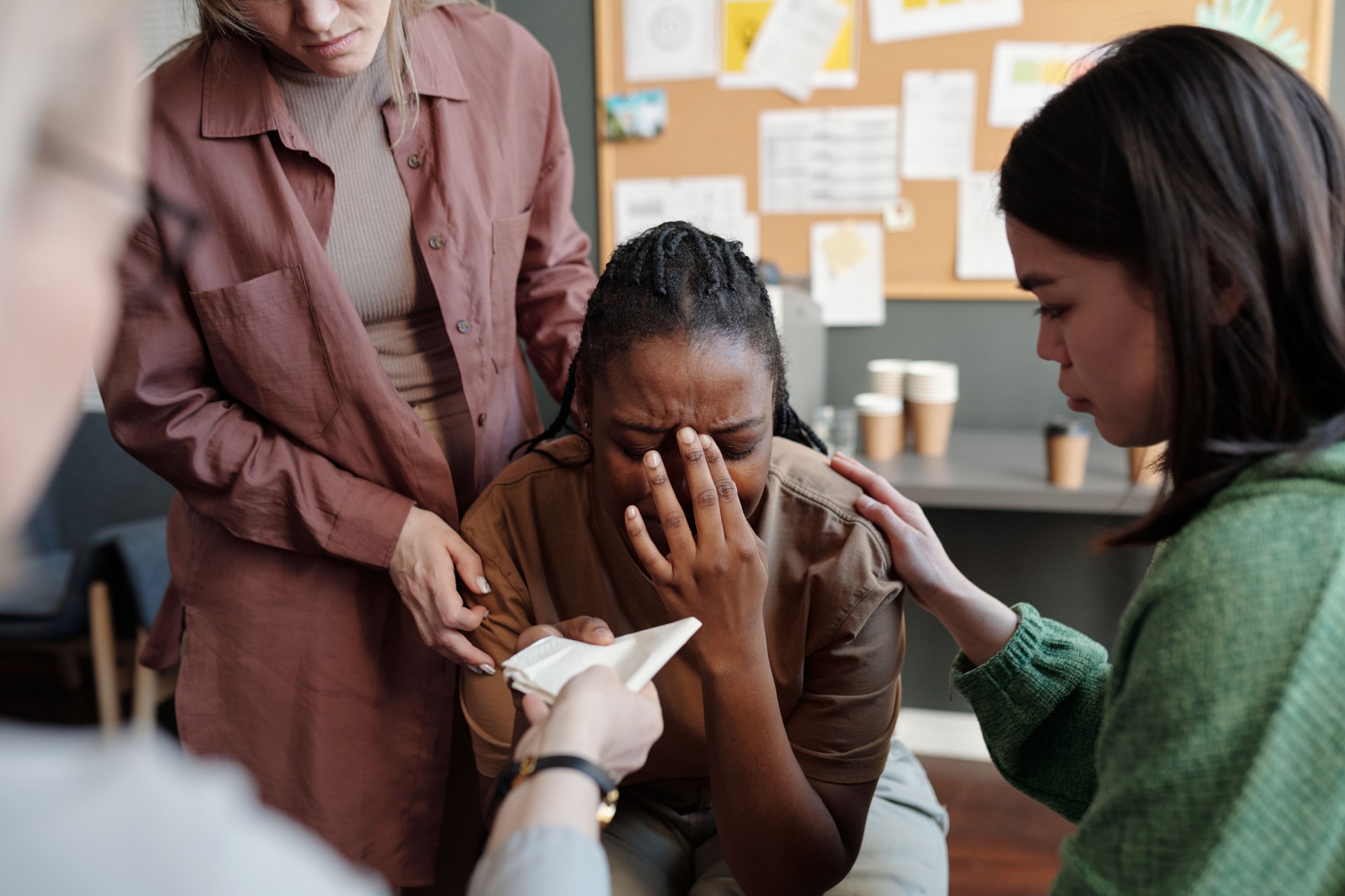 Comforting young crying woman at session
